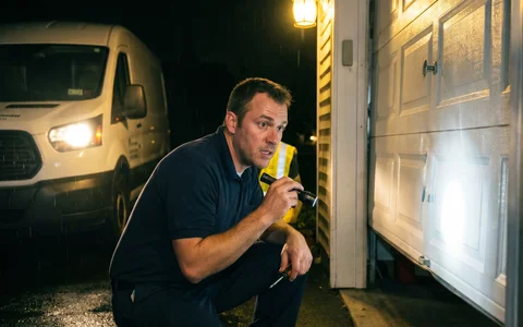 Technician responding to a 24-hour emergency garage door call at night — Rapid Garage Door Services, Hudson Valley NY